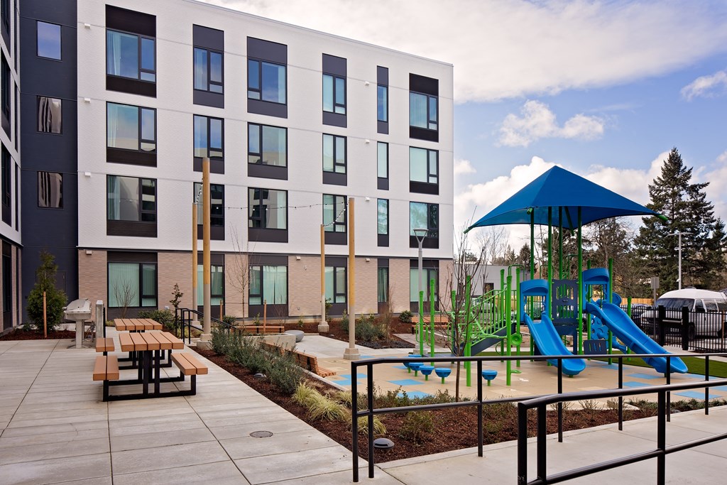Outdoor play area with picnic benches