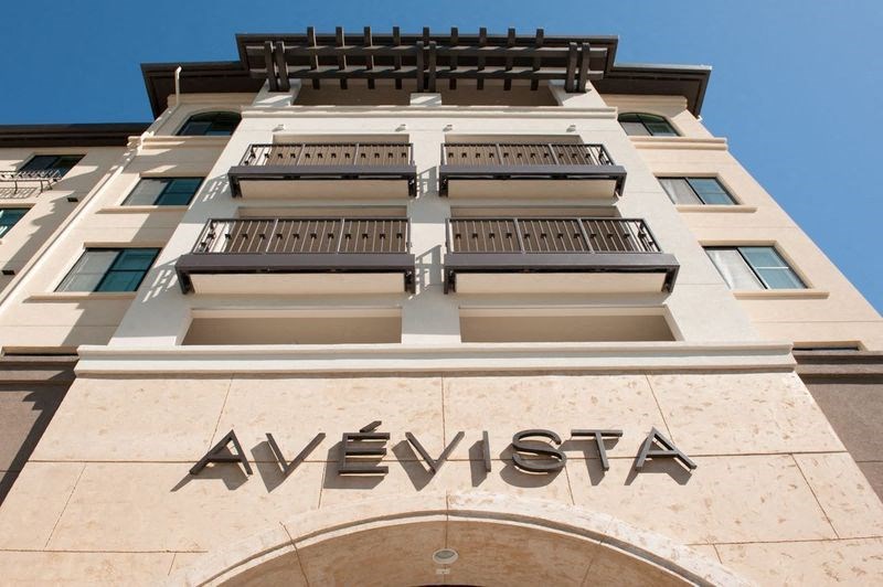 a large building with a blue sky in the background
