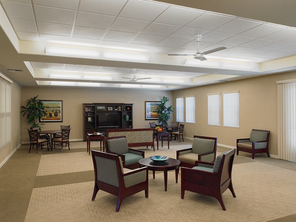 a waiting room with chairs and tables and a couch