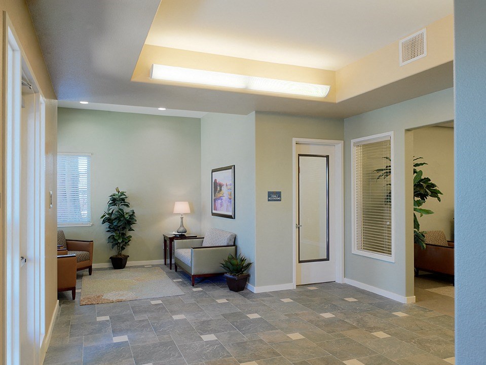 a lobby with a couch and a chair and a door