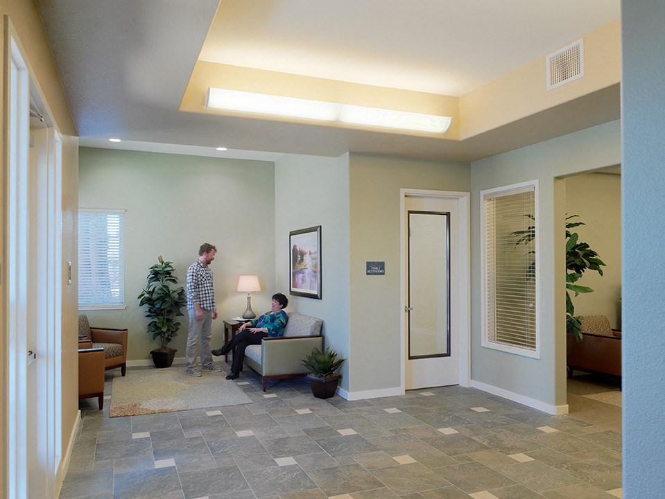 a man sitting in a chair in a waiting room with a patient