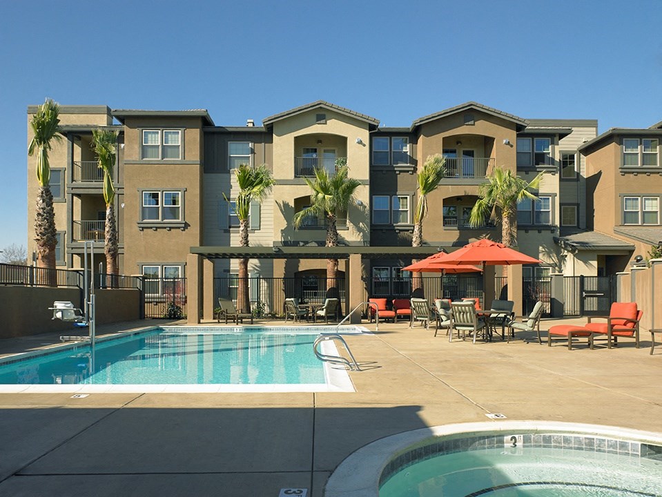 a swimming pool in front of an apartment building