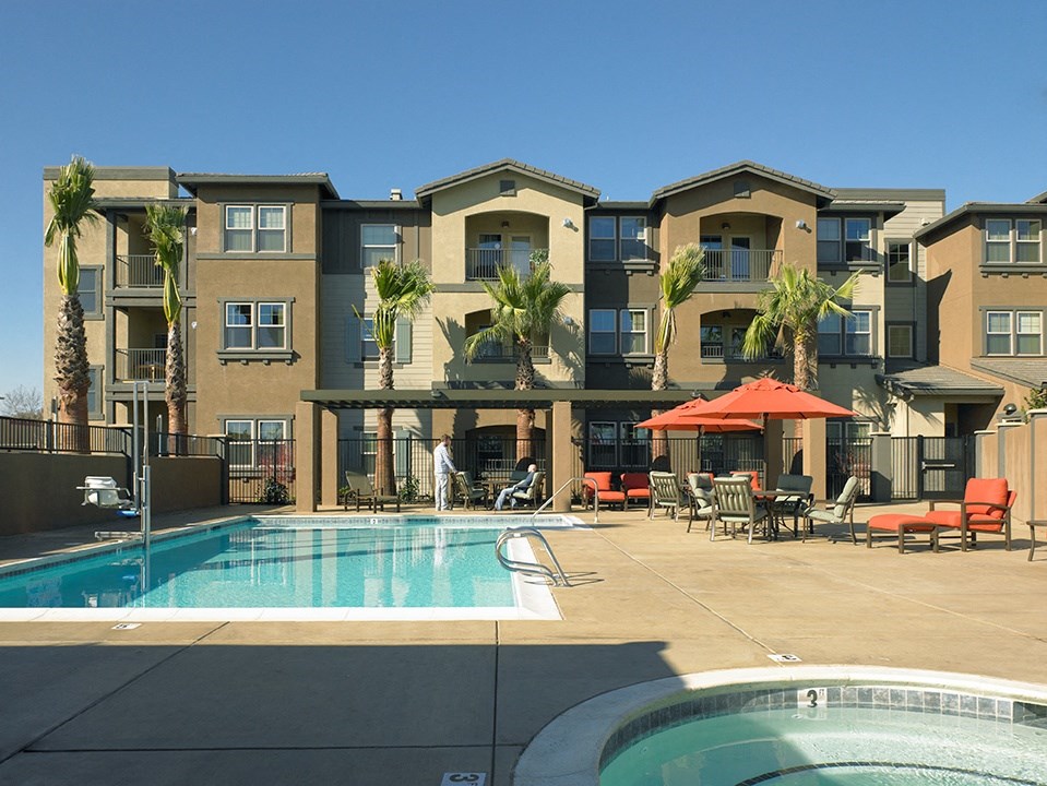 a swimming pool in front of an apartment building