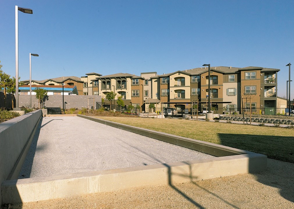 an empty street with a row of apartments in the background