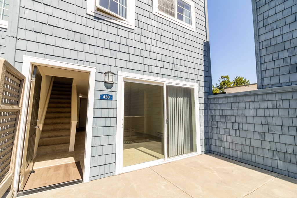 a sliding glass door on the patio of a house
