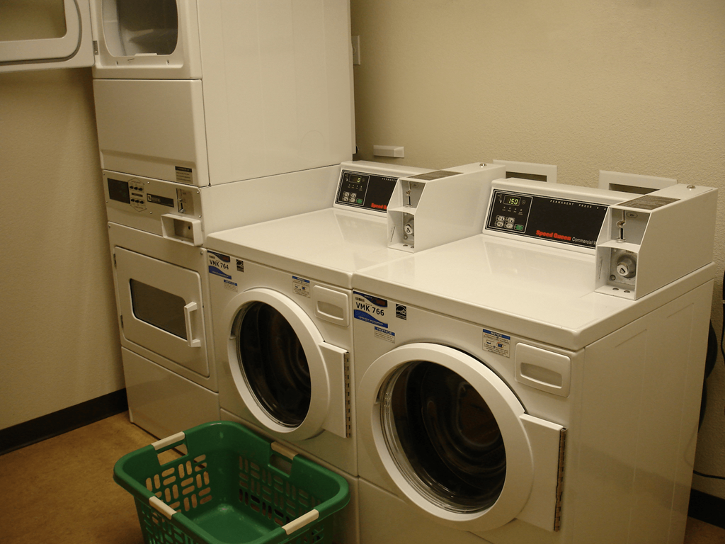 a row of washing machines in a laundry room