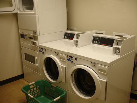 a row of washing machines in a laundry room