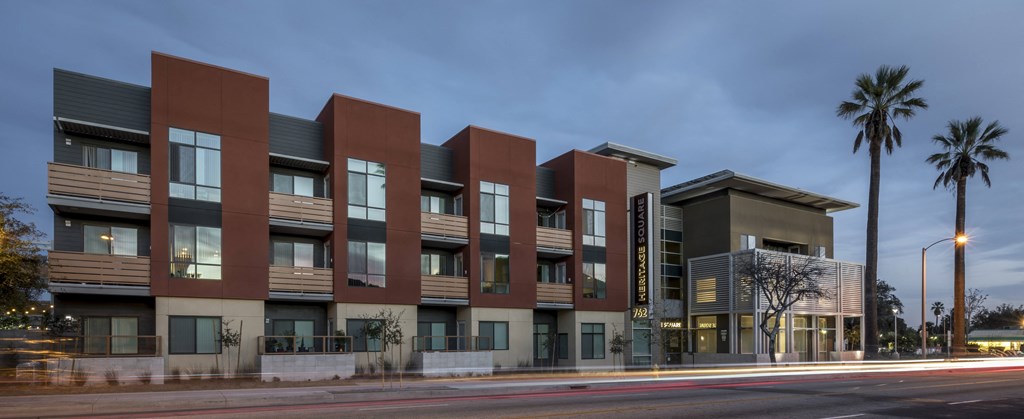 a row of modern apartment buildings on a city street