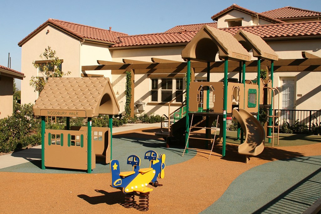 a childrens playground in front of a house