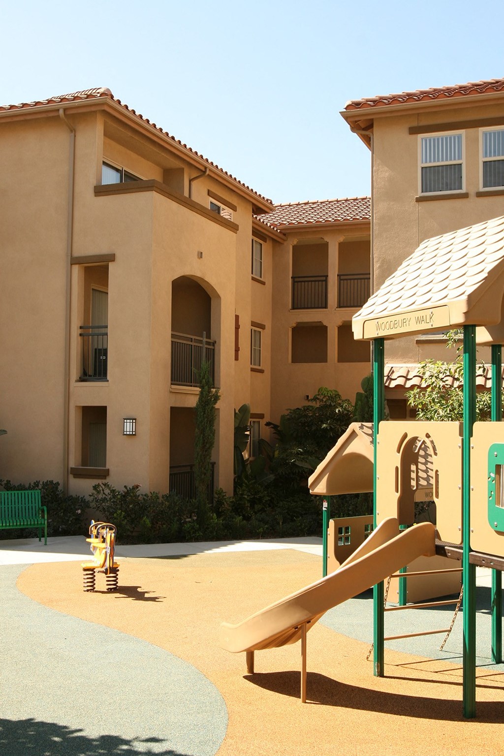 a playground in front of an apartment building