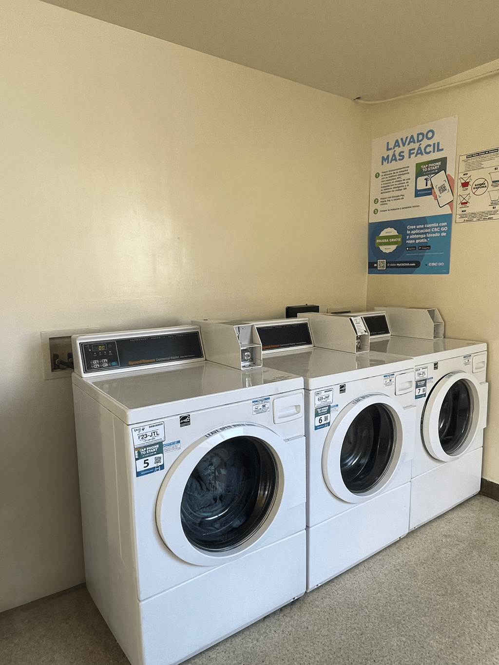 a laundry room with two washes and a dryer