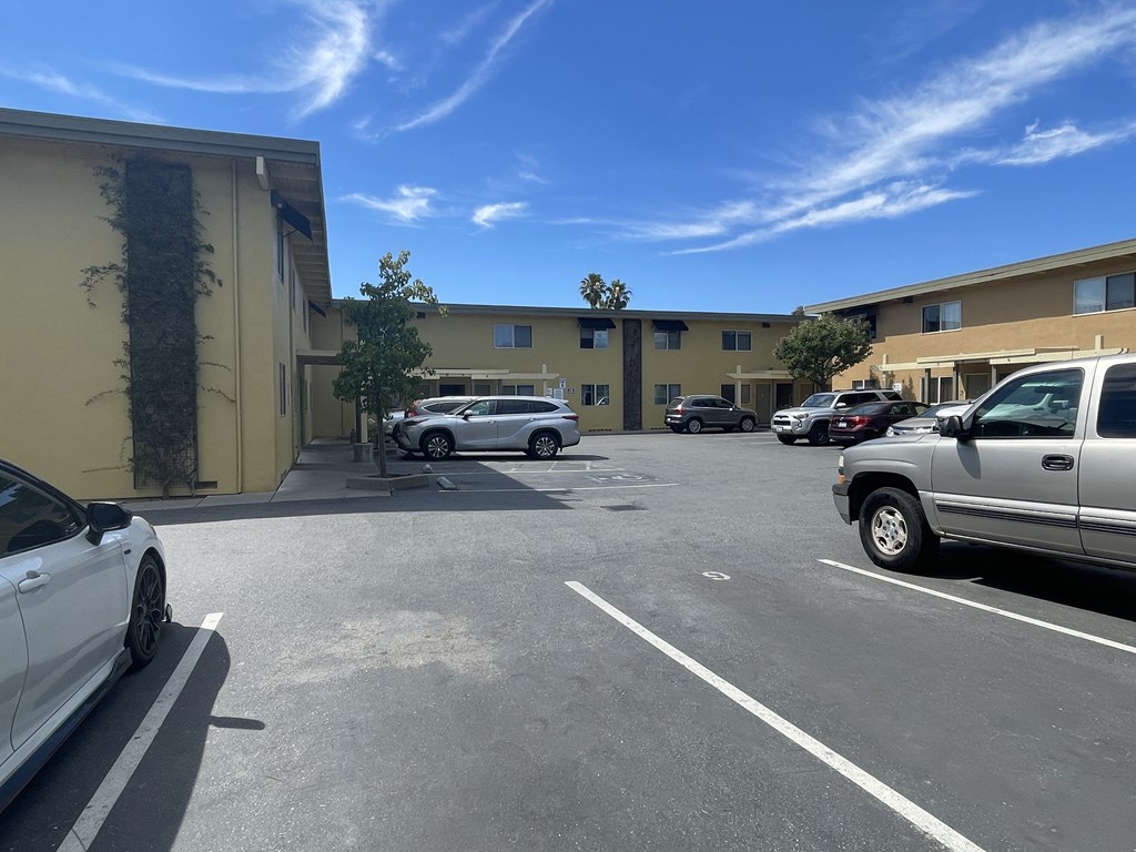 a parking lot with cars in front of a building