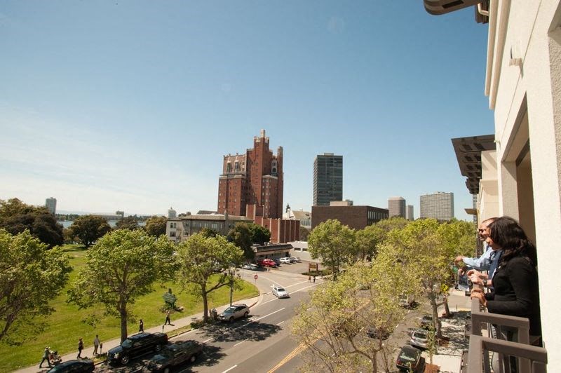 people overlooking the city from a balcony of a building