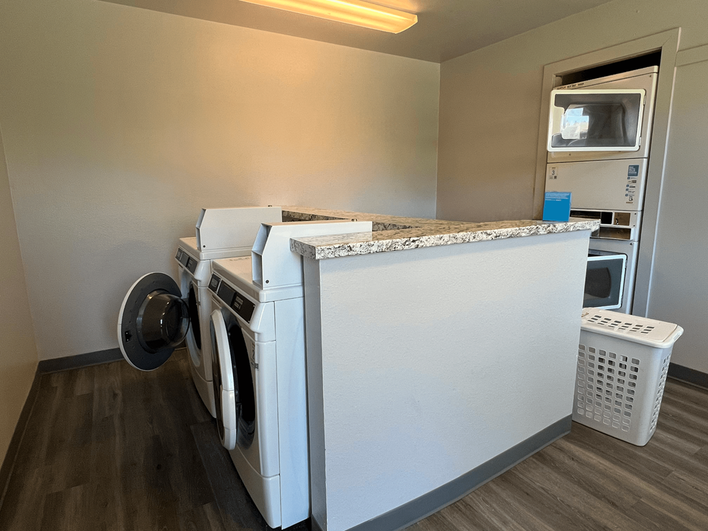 A white washing machine and dryer in a small laundry room.