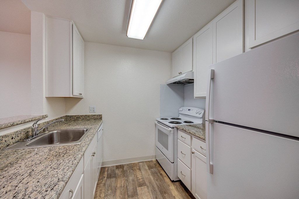 the preserve at ballantyne commons apartment kitchen with granite counter tops and white appliances