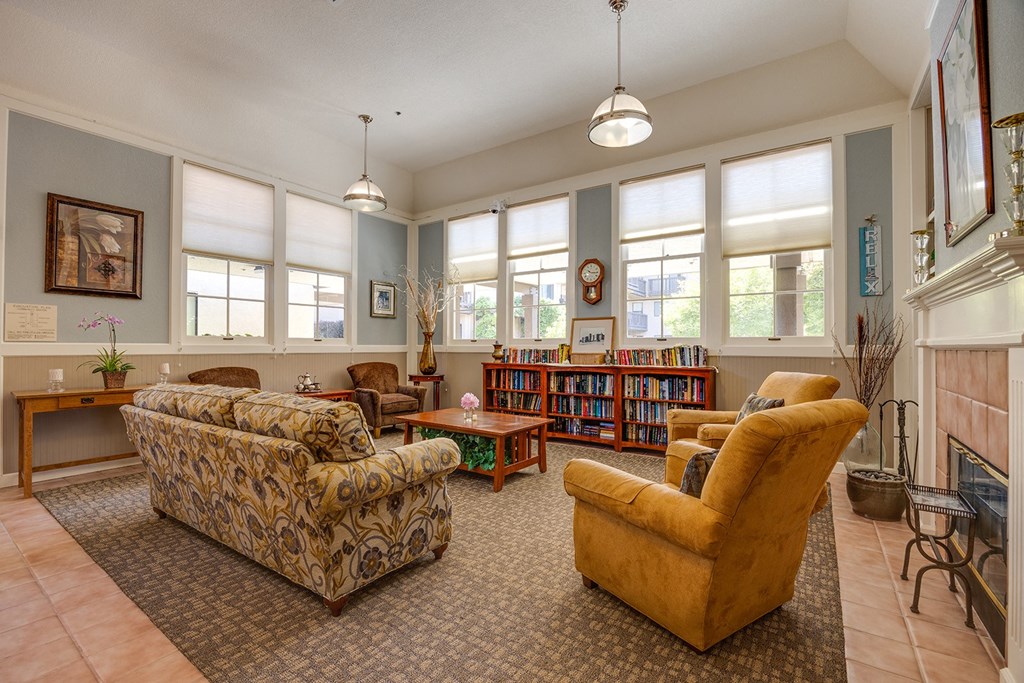 a living room with couches and chairs and a fireplace