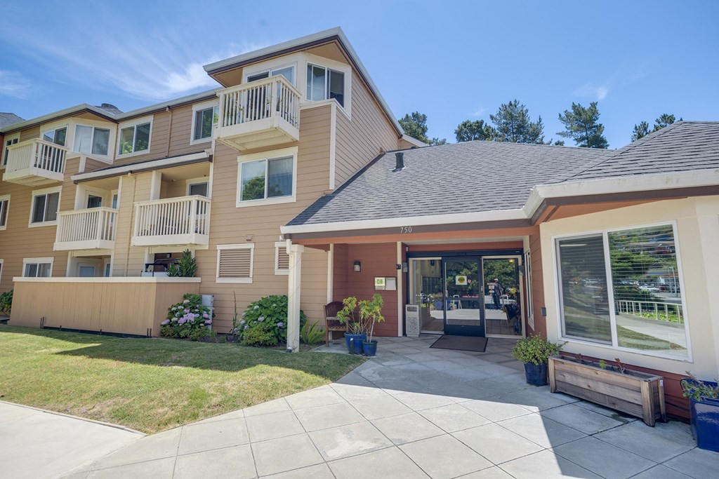the view of a building with a driveway and a glass door