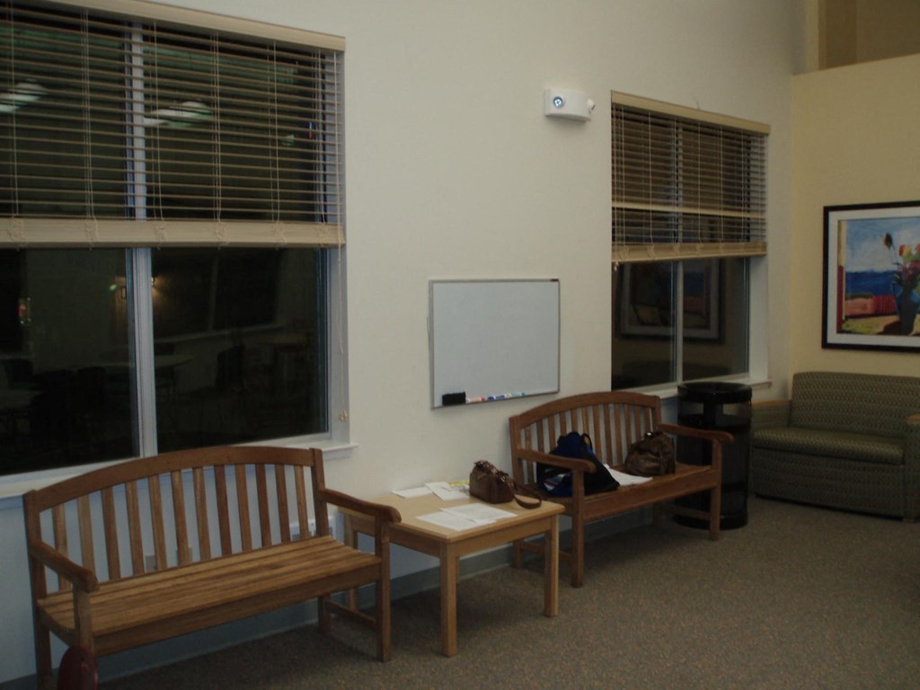 a seating area with two benches and a table and a window