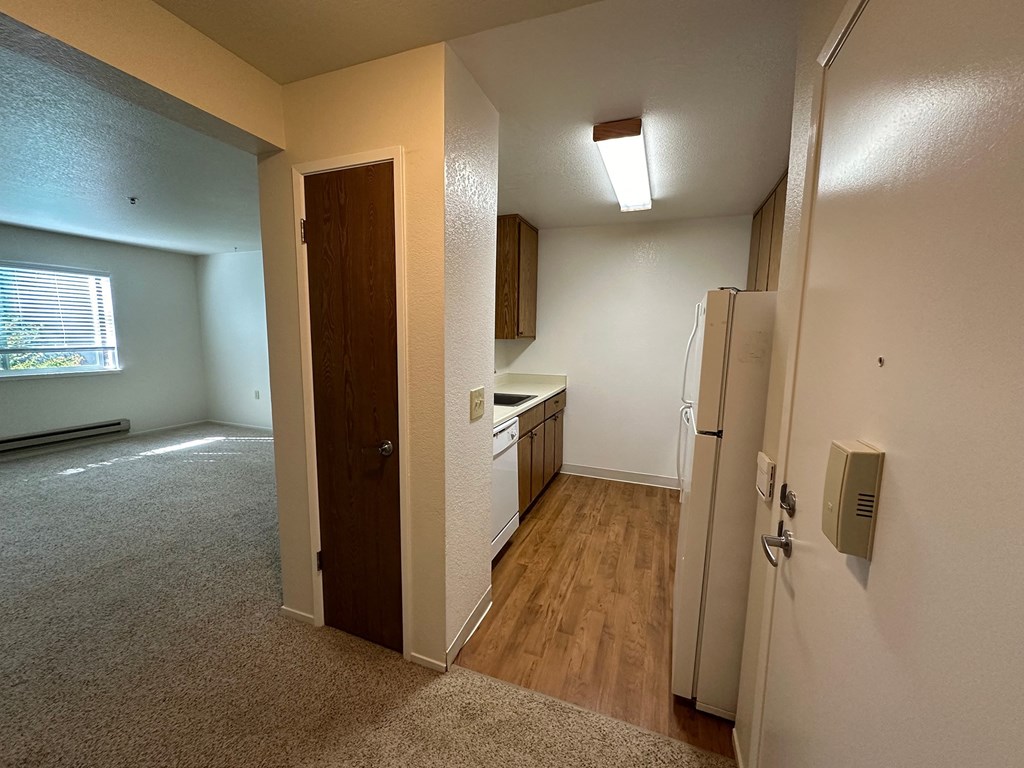 an empty kitchen and living room in an empty apartment