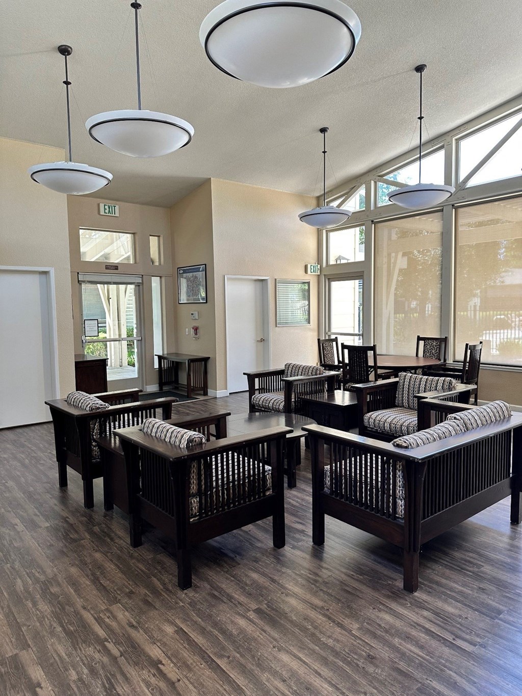 a dining room with tables and chairs in front of large windows