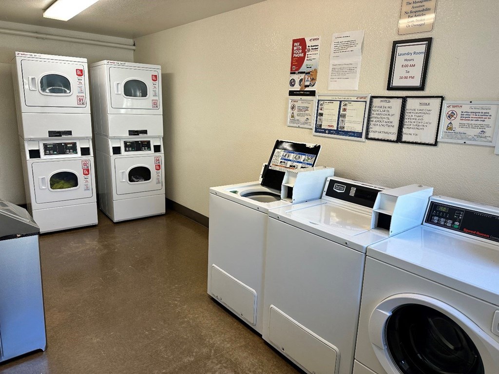 a laundry room with washing machines and other washer and dryers