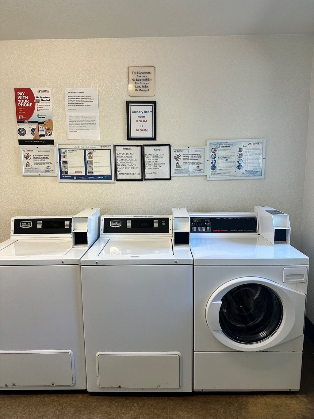 a laundry room with two washing machines and labels on the wall