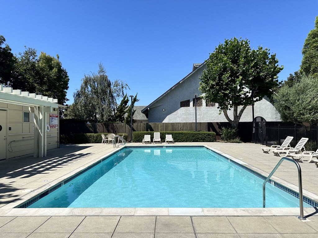a swimming pool in the backyard of a house