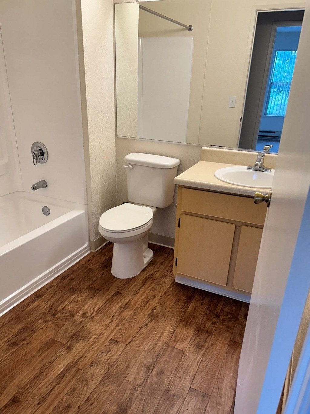 a bathroom with a toilet and a sink and a bath tub