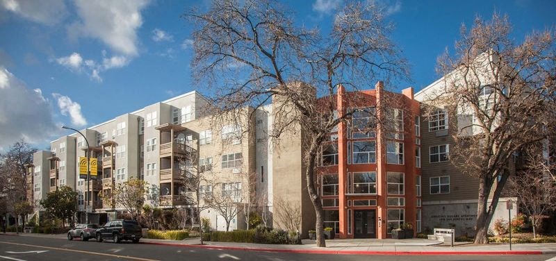 a row of apartment buildings on a city street
