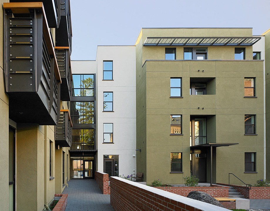 a row of modern apartment buildings with a pathway