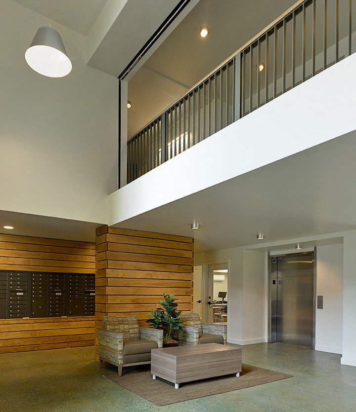 a large lobby with a couch and a coffee table