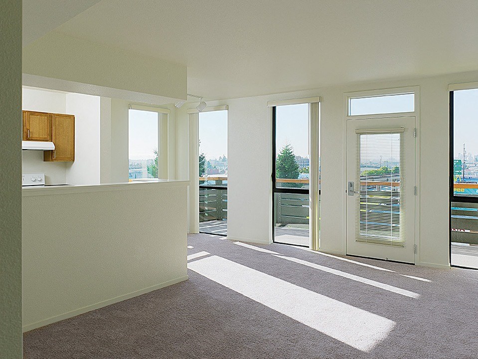 a living room with a view of a balcony and a door