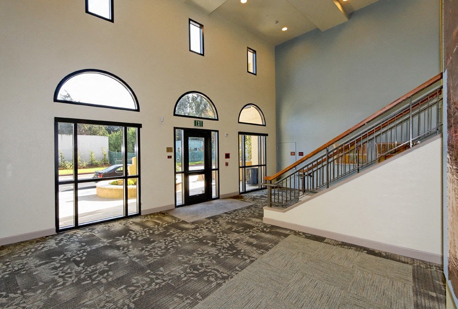 the entryway of a house with doors and a staircase
