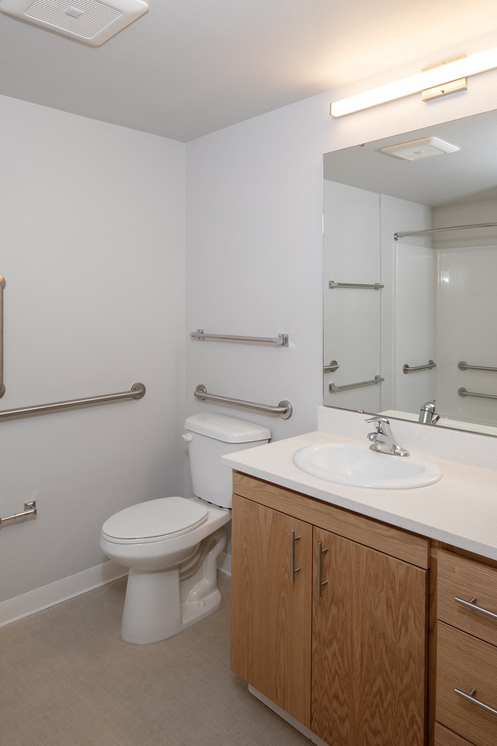 a bathroom with a sink toilet and a mirror