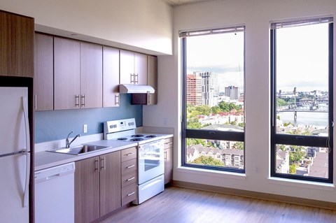 an empty kitchen with a large window overlooking a city