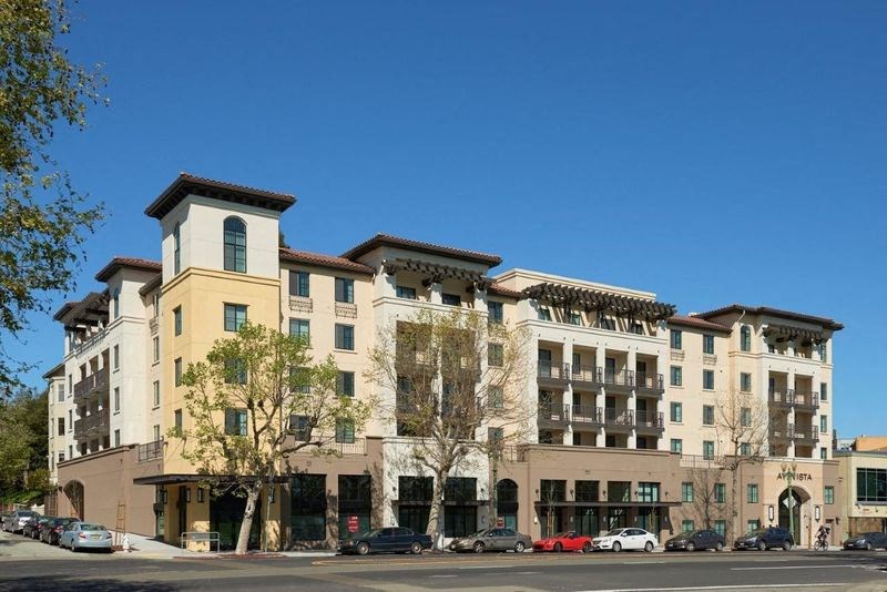a large building with cars parked in front of it