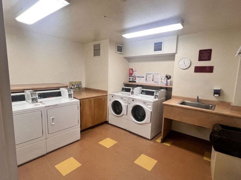 a laundry room with washing machines and dryers