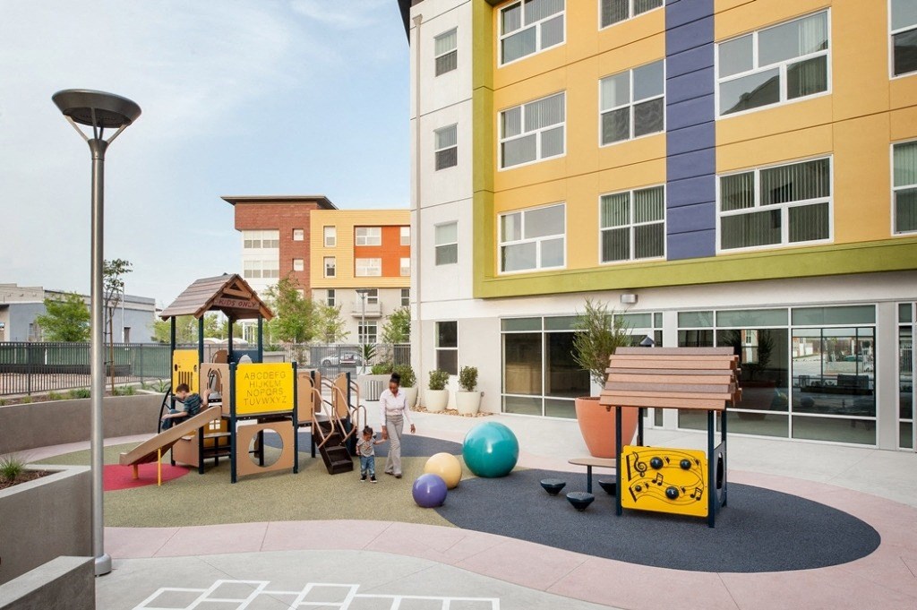 a childrens play area in the courtyard of an apartment building