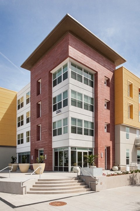 a brick building with stairs in front of it