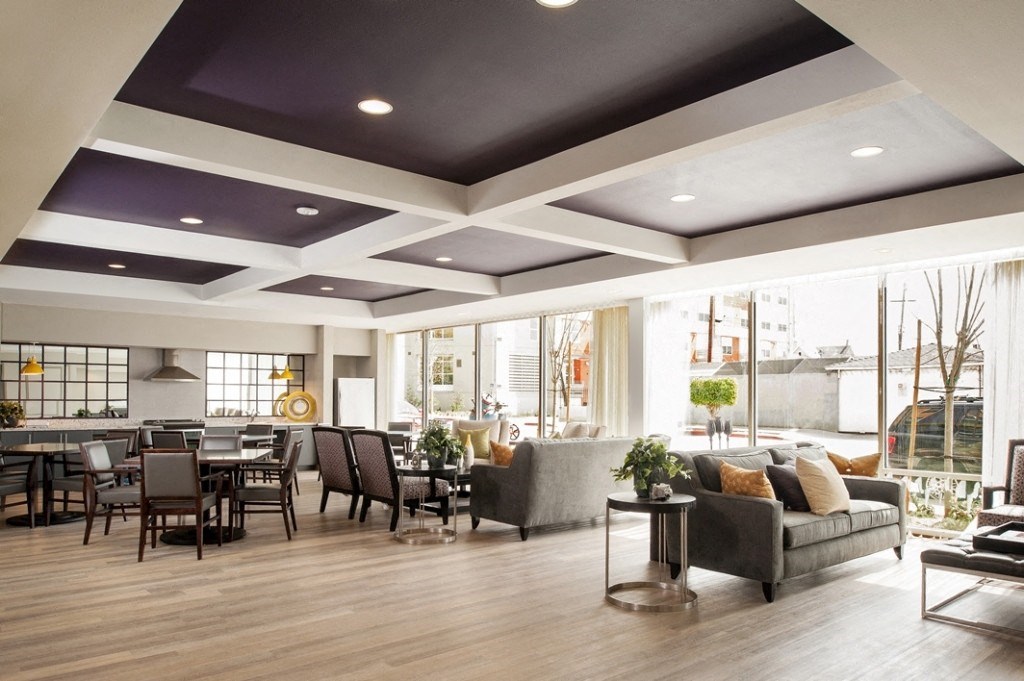 a living room with couches and chairs and a dining room table