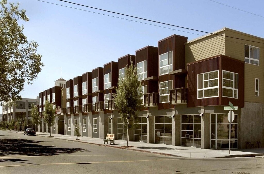 a row of apartment buildings on the corner of a street