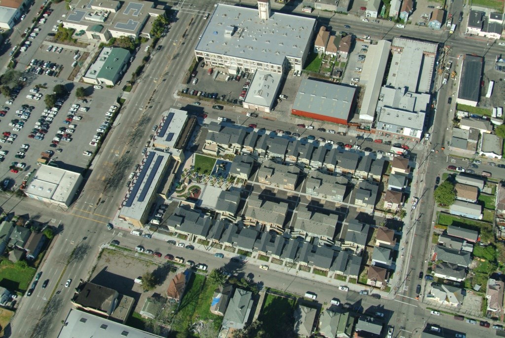 an aerial view of a parking lot and cars in a city