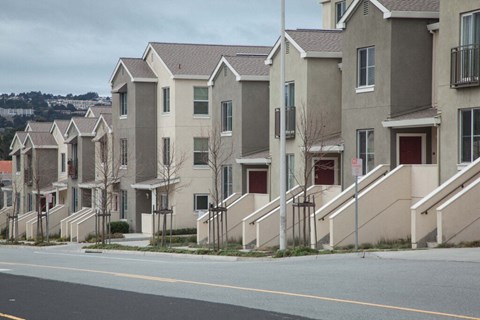 a row of houses on a street with a road