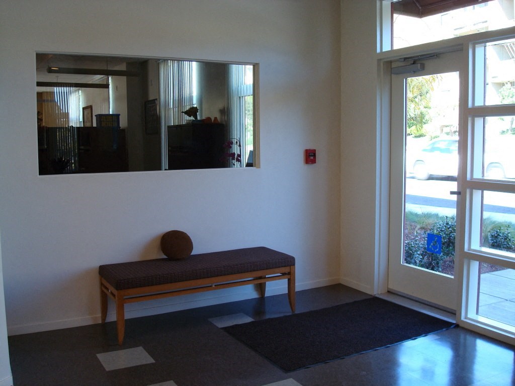 a meditation room with a bench and a mirror