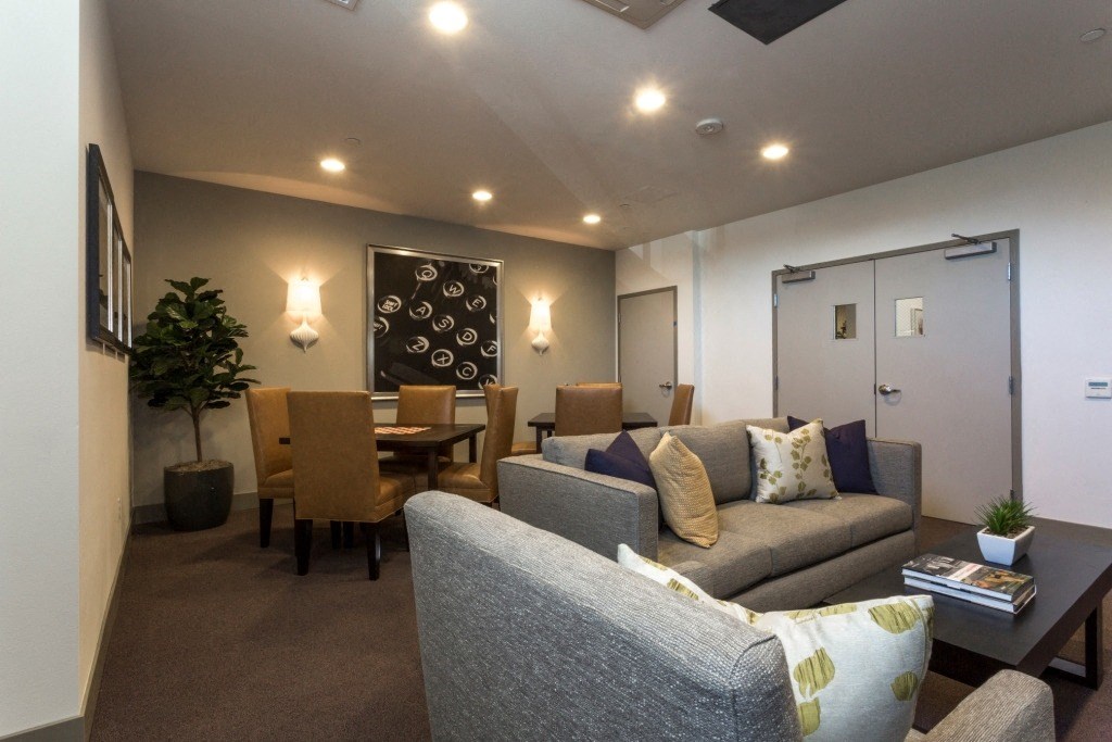 a living room with couches and chairs and a dining room table