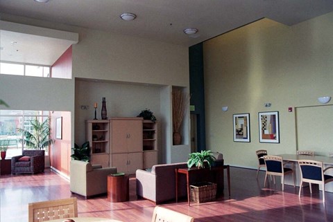 a living room and dining room with a table and chairs