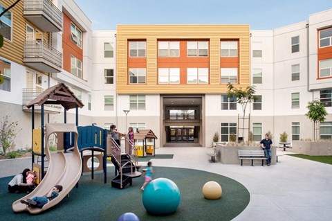 children playing in a playground in a courtyard