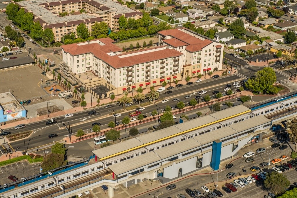 an aerial view of a city with a train    and buildings