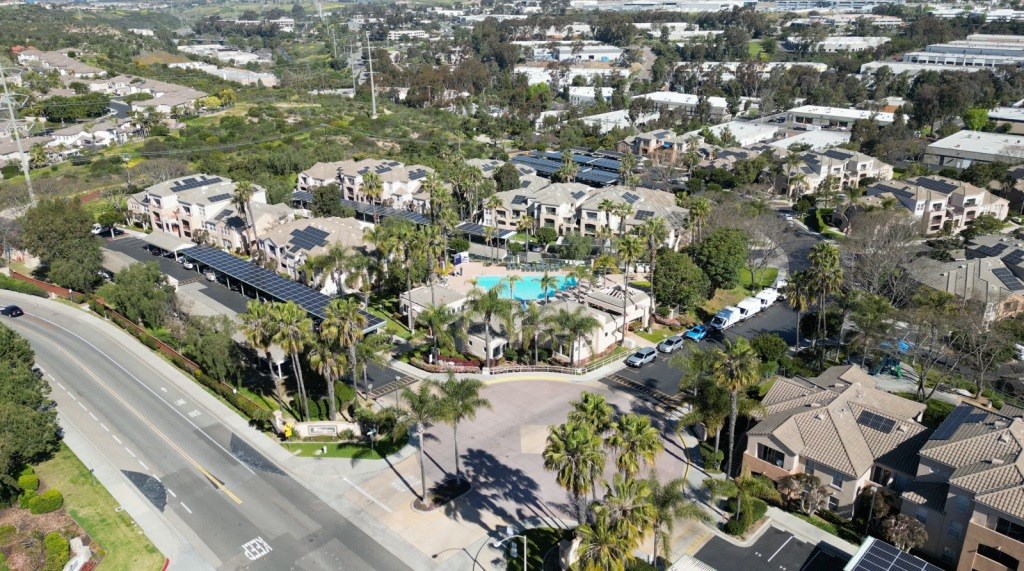 a aerial view of a neighborhood of houses and a swimming pool