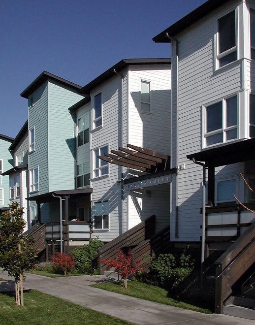 a row of houses with a sidewalk in front of them